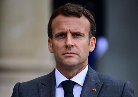 French President Emmanuel Macron looks on as NATO Secretary General talks to the press after a meeting to prepare the upcoming NATO summit, at the Elysee Palace in Paris, on May 21, 2021. (AFP)