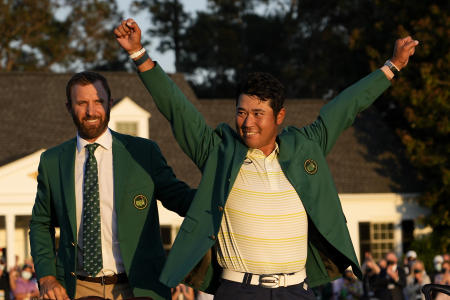 In this Sunday, April 11, 2021 file photo, Hideki Matsuyama, of Japan, puts on the champion's green jacket after winning the Masters golf tournament as Dustin Johnson watches. (AP)