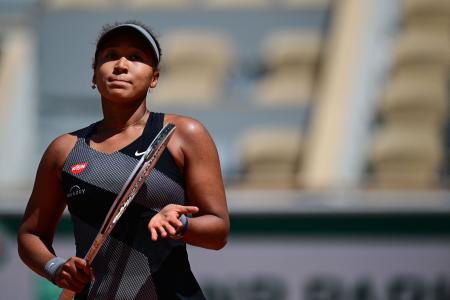 Japan's Naomi Osaka celebrates after winning against Romania's Patricia Maria Tig during their women's singles first round tennis match on Day 1 of The Roland Garros 2021 French Open tennis tournament in Paris on May 30, 2021. (AFP)