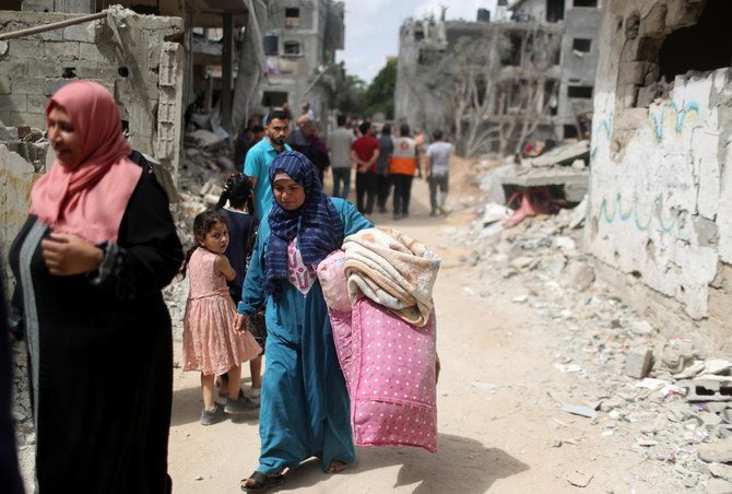 Palestinians return to their destroyed houses following Israel- Hamas truce, in Beit Hanoun in the northern Gaza Strip, May 21, 2021. (Reuters)