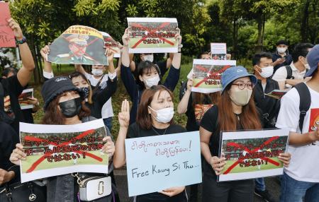 Myanmarese residents in Japan protest against the military takeover, outside the Fukuda Denshi Arena where the Asian qualification soccer match between Myanmar and Japan for the FIFA World Cup Qatar 2022 is held, in Chiba, east of Tokyo, Friday, May 28, 2021. (AP)