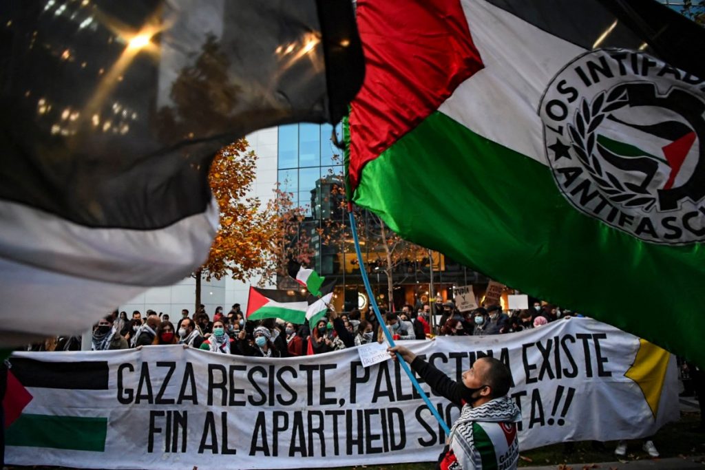 Members of the Palestinian community in Chile protest on May 19, 2021 outside the Israeli Embassy in the capital, Santiago city, against Israel's military operations in Gaza. (AFP)