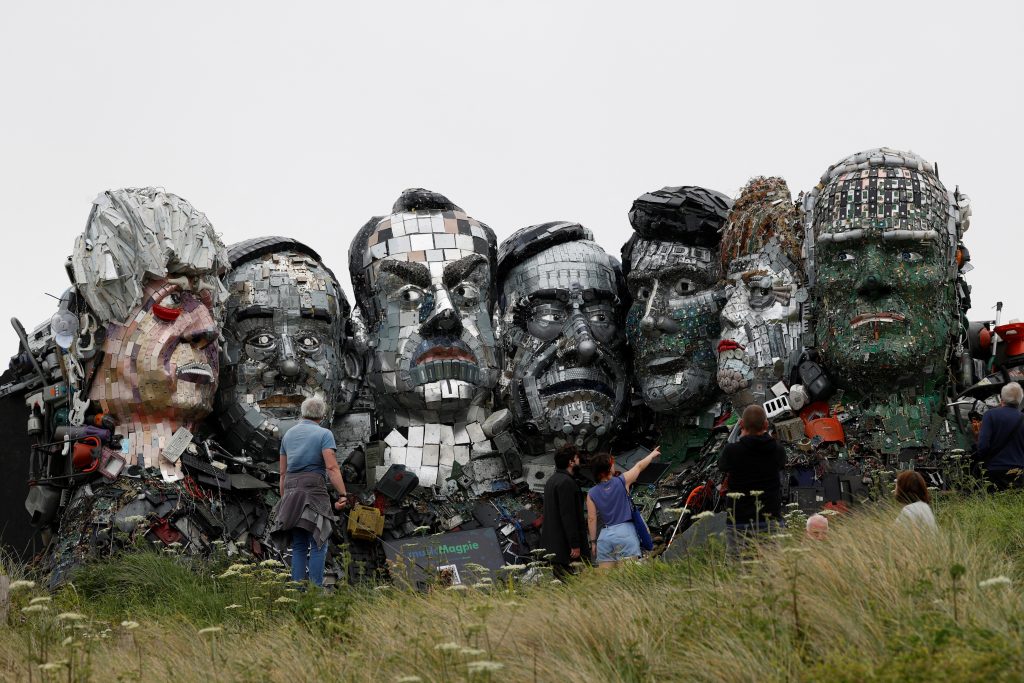 The sculpture features Boris Johnson, Yoshihide Suga, Emmanuel Macron, Mario Draghi, Justin Trudeau, Angela Merkel and Joe Biden (L-R). (AFP)