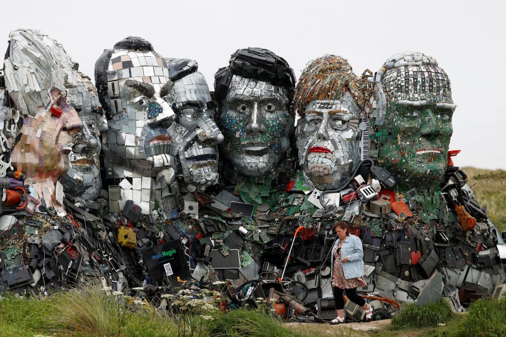 The sculpture features Boris Johnson, Yoshihide Suga, Emmanuel Macron, Mario Draghi, Justin Trudeau, Angela Merkel and Joe Biden (L-R). (AFP)