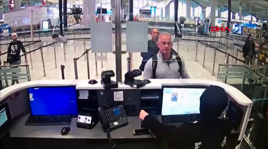 This file handout video grab image released by the Istanbul Police Department to DHA News Agency on January 17, 2020 shows Michael Taylor (2nd R) and George Antoine Zayek (C) at passport control in Istanbul Airport - two men accused of helping fugitive businessman Carlos Ghosn escape via an Istanbul airport as he fled a corruption trial in Japan. (AFP)