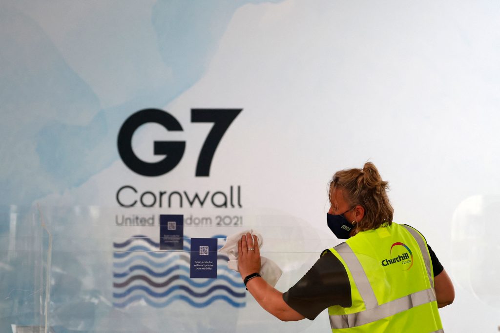 A worker cleans partitions at the G7 media centre in Falmouth, Cornwall on June 10, 2021, ahead of the three-day G7 summit being held from 11-13 June. (AFP)