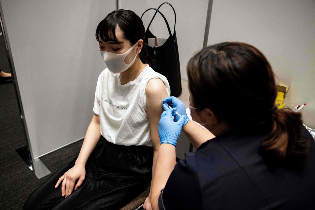 An employee of Japan's Mori Building Company, a property management firm, receives the Moderna coronavirus vaccine for Covid-19 during the company's workplace vaccination campaign in Tokyo on June 21, 2021. (AFP)