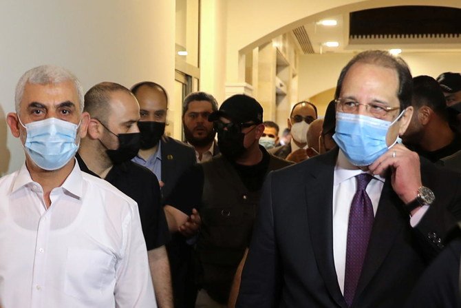 Palestinian Hamas Gaza Chief Yehya Al-Sinwar and head of the Egyptian general intelligence Abbas Kamel walk as they meet in Gaza, May 31, 2021. (Reuters)