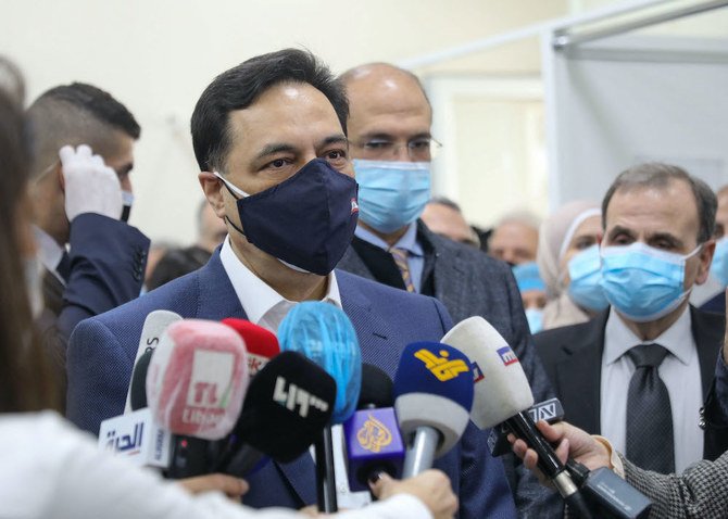 Lebanon’s caretaker premier Hassan Diab talks to reporters at the Rafik Hariri Hospital in the capital Beirut. (File/AFP)