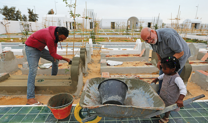 Algerian artist Rachid Koraichi at the cemetery in southern Tunisia for migrants who drowned crossing the Mediterranean in the hope of a better life in Europe. (AFP)