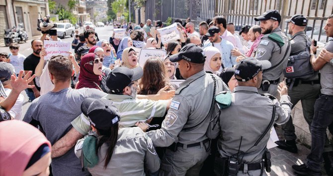 Palestinians outside the Israeli Central Court in East Jerusalem demonstrate against the planned eviction of Arab families from the city’s Silwan district. (AFP)