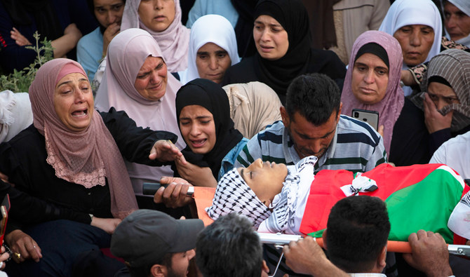 Palestinian women mourn during the funeral of Mohammad Hamayel, 15, who was killed during clashes with Israeli security forces in Beita, West Bank, on June 11, 2021. (AP Photo/Majdi Mohammed)