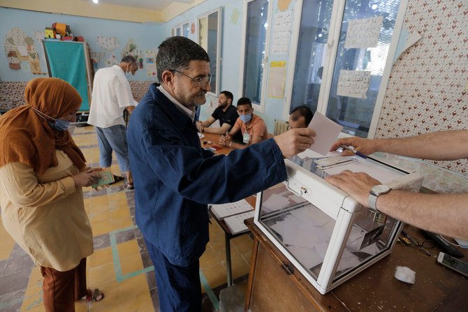 Algerians cast their votes in Algiers on June 12, 2021 in the country's first legislative elections since the ouster of ex-president Bouteflika. (AP Photo/Toufik Doudou)