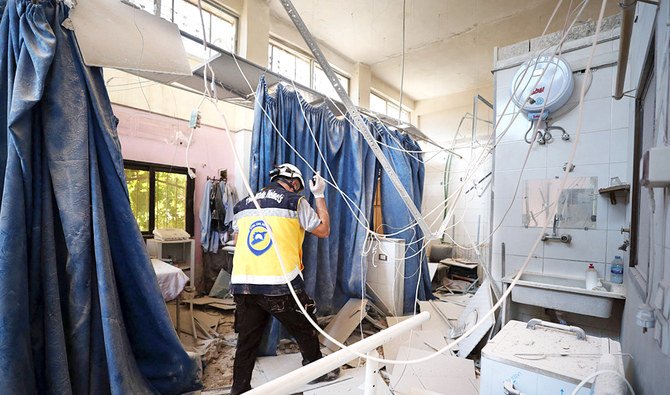 A member of Syria’s Civil Defence service inspects the damage caused by the shelling at Al-Shifaa hospital in Afrin, Syria. (AFP)