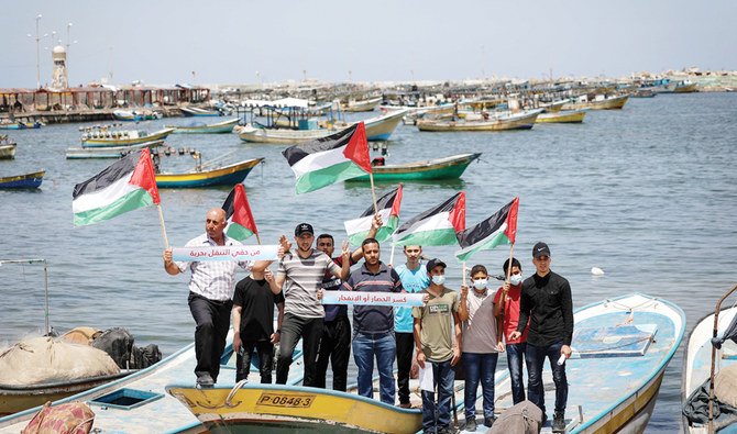 Palestinian fishermen stage a demonstration at the Gaza seaport against the Israeli authorities’ reduction of the fishing area to six nautical miles. (File/AFP)