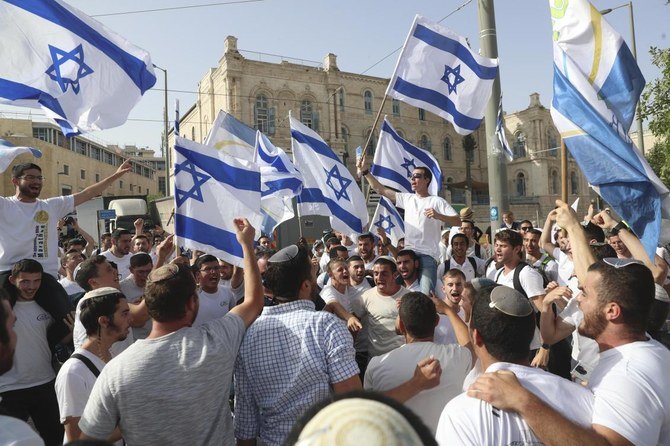 In this May 10, 2021, file photo, Israelis wave national flags during a Jerusalem Day parade, in Jerusalem. (AP File)