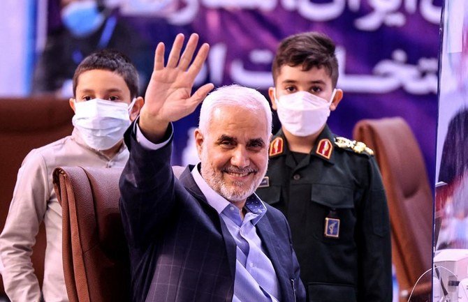 Former Iranian vice president Mohsen Mehralizadeh, accompanied by his grandsons, salutes supporters as he registers his candidacy at the Interior Ministry in the capital Tehran on May 13, 2021. (File/AFP)