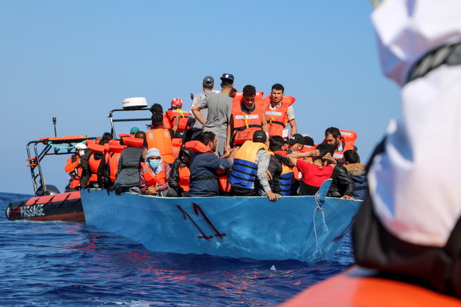 Members of Doctors Without Borders (MSF) rescue migrants from a boat off the coast of Libya, in the Mediterranean Sea, June 11, 2021. (Reuters)