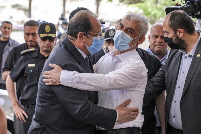 Yahya Sinwar (L), Hamas' political chief in Gaza, embraces General Abbas Kamel (R), Egypt's intelligence chief in Gaza City. (File/AFP)