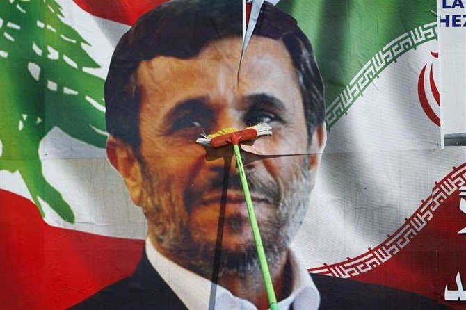 A worker puts up a billboard poster of Iranian President Mahmoud Ahmadinejad in Deir Al-Zahrani, southern Lebanon, October 9, 2010. (Reuters)