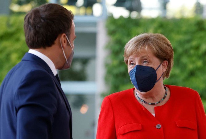 German Chancellor Angela Merkel welcomes French President Emmanuel Macron in Berlin on Friday. The EU has set out a potential criteria for Lebanese sanctions prepared for corrupt politicians. (AFP)