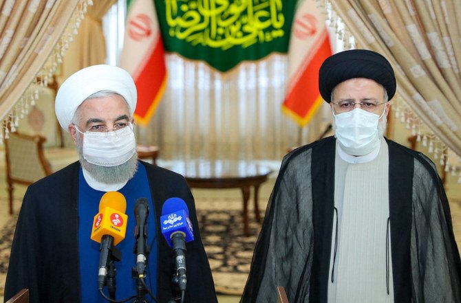 Iran President Hassan Rouhani, left, joins President-elect Ebrahim Raisi at a press conference to congratulate him on winning an election in which most serious rivals were excluded. (AFP)