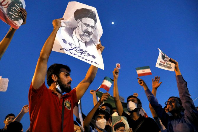 Supporters of Iranian president-elect Ebrahim Raisi celebrate in Tehran on June 19, 2021, after he won the presidential election. (AP Photo/Ebrahim Noroozi)