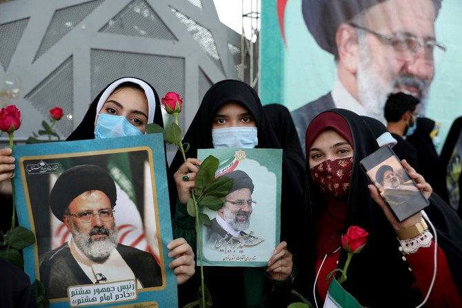 Supporters of Iranian president-elect Ebrahim Raisi celebrate in Tehran on June 19, 2021, after he won the presidential election. (AP Photo/Ebrahim Noroozi)