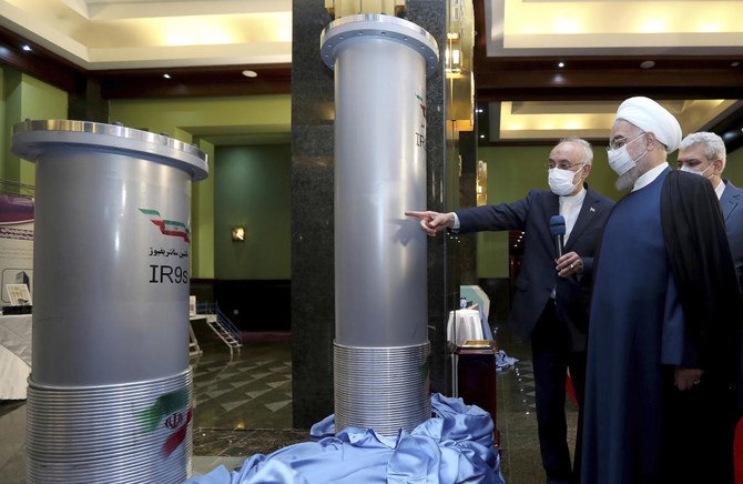 President Hassan Rouhani, second right, listens to head of the Atomic Energy Organization of Iran Ali Akbar Salehi while visiting an exhibition of Iran’s new nuclear achievements in Tehran, Iran. (Iranian Presidency Office via AP)