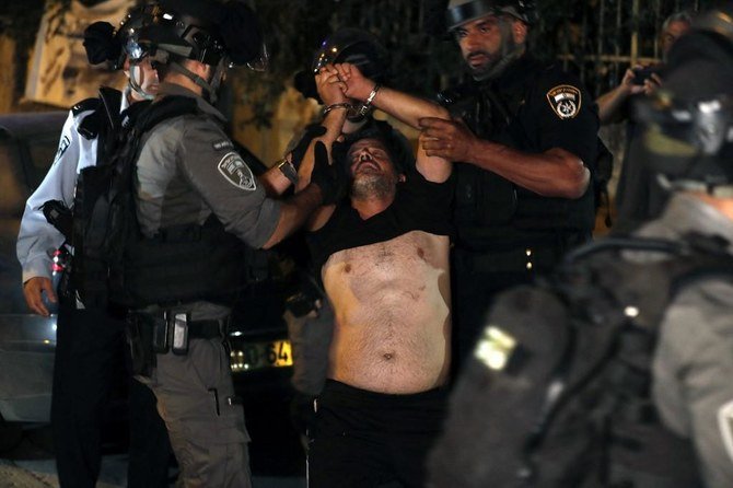 A demonstrator is arrested by Israeli security forces as Palestinian families face eviction, part of an ongoing effort by settlers to take control of homes in the Sheikh Jarrah neighborhood of Jerusalem. (AFP)