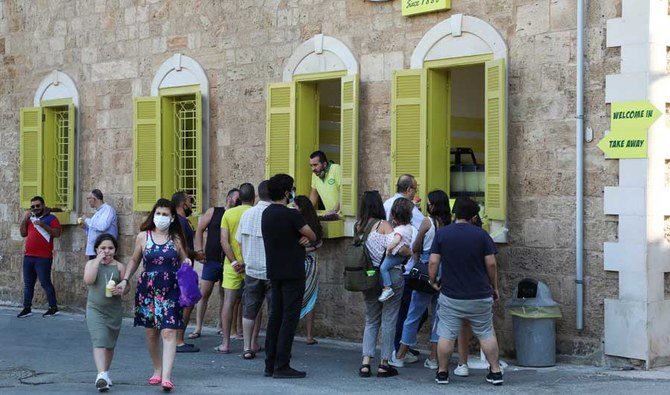 People wait to buy lemonade in Batroun, Lebanon June 5, 2021. Picture taken June 5, 2021. (REUTERS)