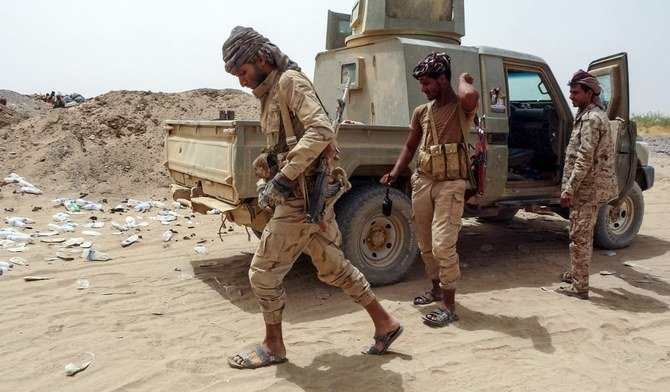 Fighters with Yemen’s government man a position near the frontline facing Houthis in the northeastern province of Marib, on June 19, 2021. (File/AFP)