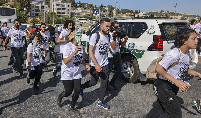 Palestinian youths take part in a marathon race event organized by activists between the neighborhoods of Sheikh Jarrah and Silwan in East Jerusalem. (File/AFP)