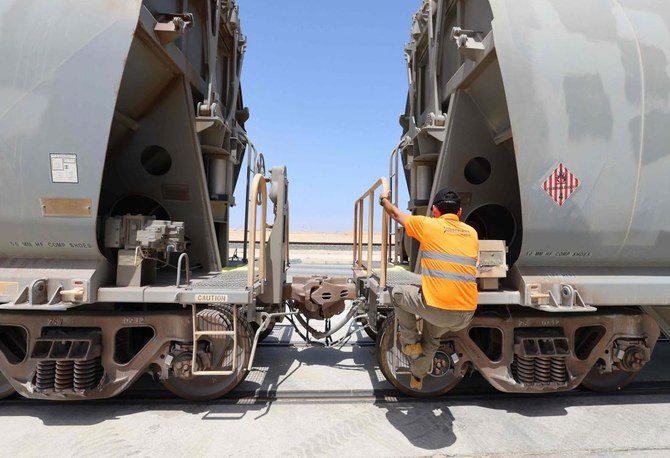 A picture taken on April 1, 2021 shows a technician working at waggons of the Etihad Rail network, in Al-Mirfa, in the United Arab Emirates. (AFP)