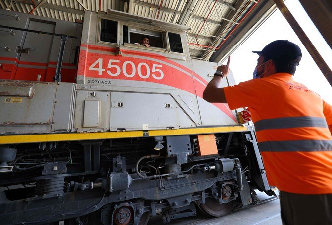 Employees working in the main wagon of a train of the Etihad Rail network, in Al-Mirfa, in the United Arab Emirates. (AFP/Giuseppe Cacace)