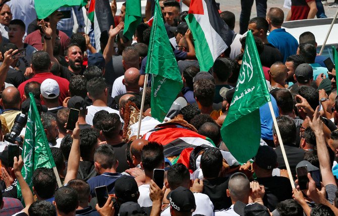 Mourners join a funeral procession in Hebron on June 25, 2021, for Nizar Banat, who died a day after Palestinian Authority police arrested for denouncing corruption. (AFP / MOSAB SHAWER)