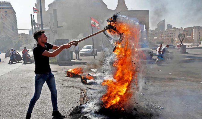 Demonstrators burn tires during a demonstration against dire living conditions amid the ongoing economical and political crisis, in Beirut. (AFP)