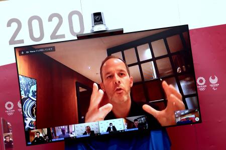 IOC’s Olympic Games Operations Director Pierre Ducrey speaks on-screen during a press briefing for the presentation of version three of the Tokyo 2020 Playbook in Tokyo on June 15, 2021. (AFP)