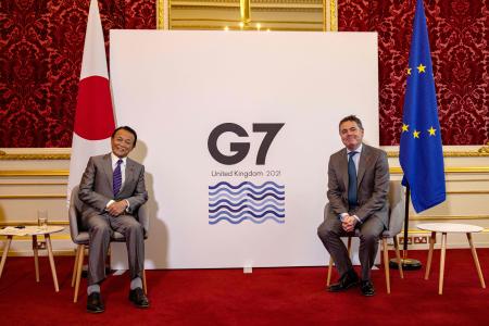 Japan's Finance Minister Taro Aso (left) and Eurogroup President Paschal Donohoe bump elbows as they pose for a photograph during their meeting on the second day of the G7 Finance Ministers Meeting, at Lancaster House in London on June 5, 2021. (AFP)