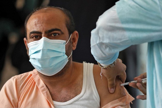 A Yemeni health worker receives a dose of the AstraZeneca COVID-19 vaccine at a vaccination centre in Yemen's third city of Taez, on April 21, 2021. (AFP)