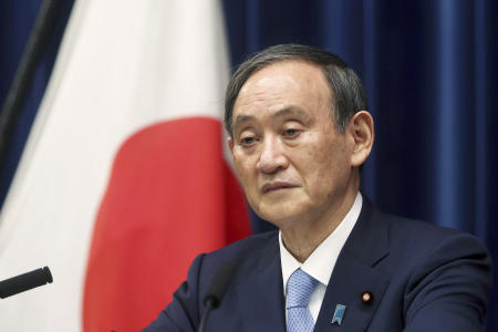 In this May 28, 2021, file photo, Japan's Prime Minister Yoshihide Suga speaks during a news conference at the prime minister's official residence in Tokyo. Suga announced Wednesday, June 2, an additional $800 million contribution to the UN-backed initiative to provide COVID-19 vaccines to poor countries, a four-fold increase of Japanese funding for the COVAX program. (AP)