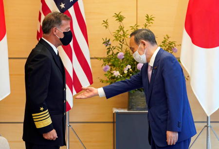 Admiral John C. Aquilino (left), Commander of the United States Indo-Pacific Command, is welcomed by Japanese Prime Minister Yoshihide Suga at the start of their meeting at the prime minister's official residence in Tokyo, Japan, June 1, 2021. (Reuters)