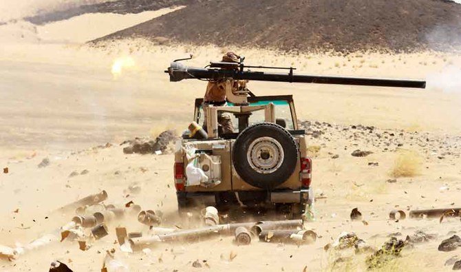A Yemeni government fighter fires a vehicle-mounted weapon at a frontline position during fighting against Houthi fighters in Marib, Yemen March 9, 2021. (REUTERS)