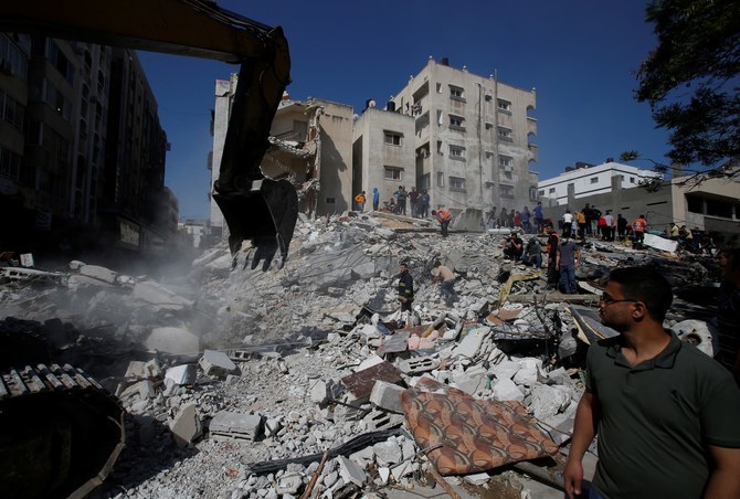 Rescue workers search for survivors, amid rubble, after Israeli airstrikes, in Gaza City, May 16, 2021. (Reuters)