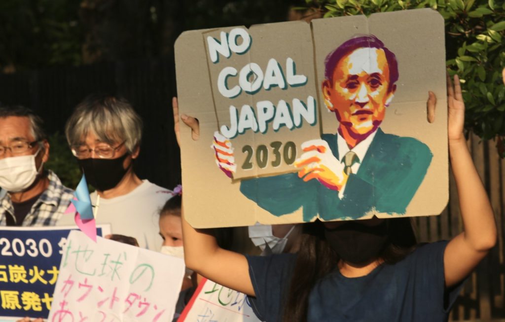 In front of the Diet, mothers carried signs that read, 