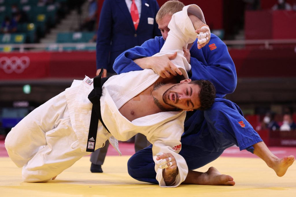 Canada's Shady Elnahas (white) and United Arab Emirates's Ivan Remarenco compete in the judo men's -100kg elimination round bout during the Tokyo 2020 Olympic Games at the Nippon Budokan in Tokyo on July 29, 2021. (AFP)