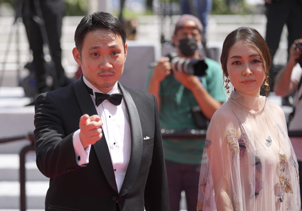 Director Ryusuke Hamaguchi, left, and Reika Kirishima pose for photographers upon arrival at the premiere of the film 'Drive My Car' at the 74th international film festival, Cannes, southern France, Sunday, July 11, 2021. (AP)