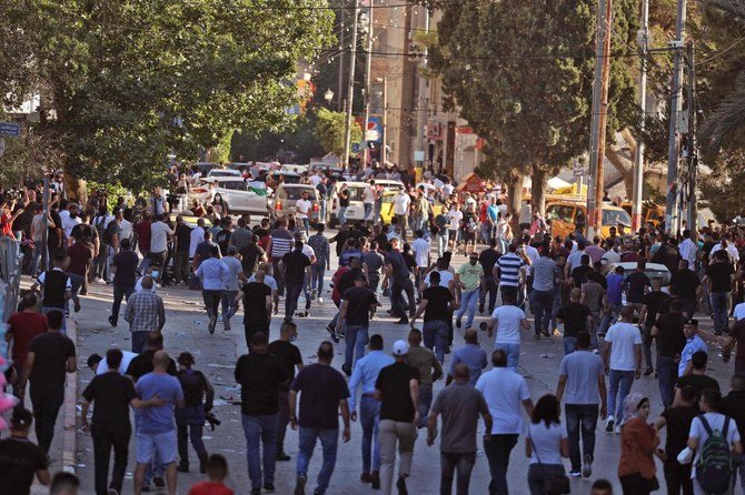 Palestinians march during a demonstration in Ramallah in the occupied West Bank to protest the death of human rights activist Nizar Banat while in Palestinian Authority (PA) security forces’ custody. (AFP)