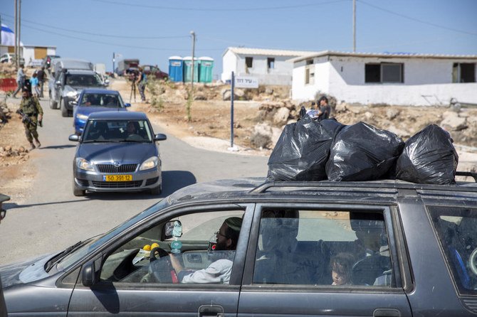 Israeli settlers leave the recently established wildcat outpost of Eviatar, near the West Bank city of Nablus, Friday, July 2, 2021. (AP Photo)