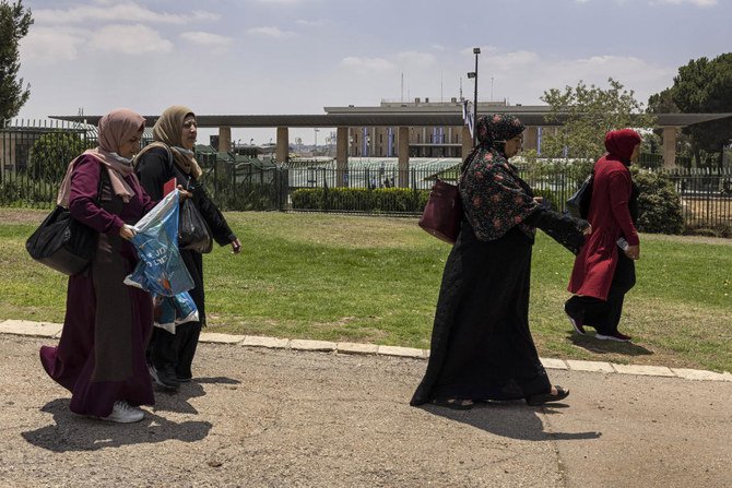 Israeli Arab women gather for a protest ahead of a vote by Israel's parliament on renewing a law that bars Arab citizens of Israel from extending citizenship or even residency to spouses from the occupied West Bank and Gaza, Monday, July 5, 2021.(AP)